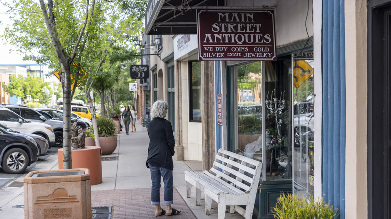 A woman standing in front of antique store in downtown St. George