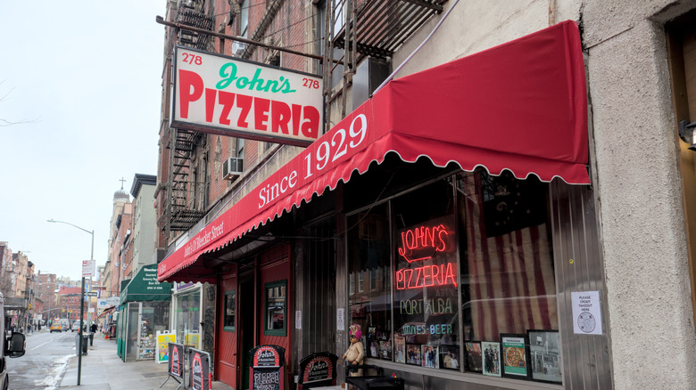 The exterior of John's on Bleecker Street, showing signage and an awning