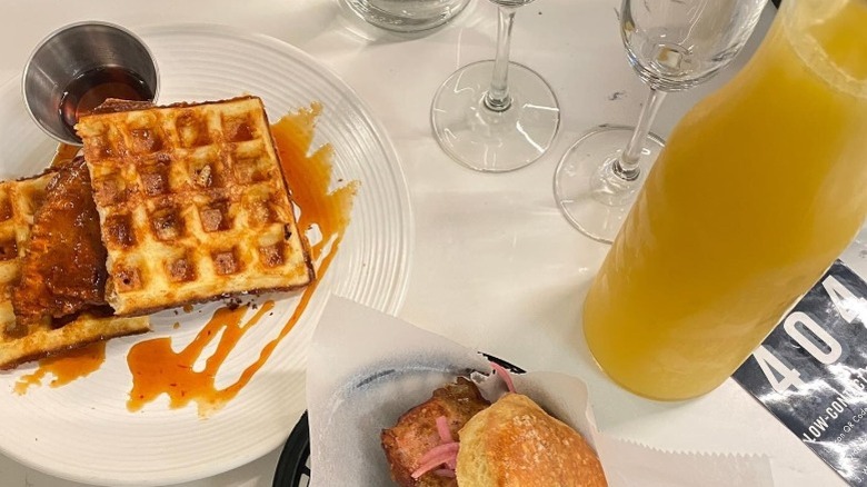 A carafe of mimosas with yeasty waffles at Stay Golden Nashville