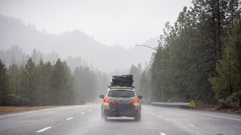 packed car drives in rain