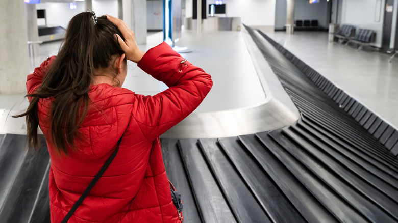 frustrated traveler empty baggage carousel  