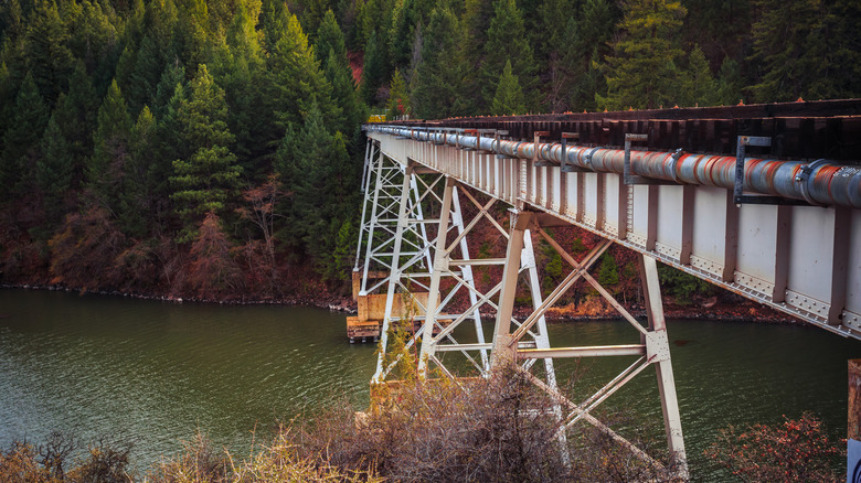 Side view of the Stand By Me Bridge with its supporting legs and the lake below it.