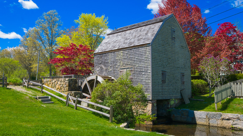 Dexter Grist Mill surrounded by foliage in Sandwich, Cape Cod