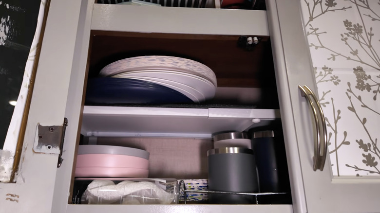 A DIY camper cabinet build with extra shelving options inserted to make use of space
