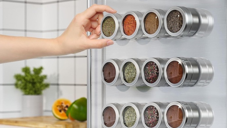 A 12-jar magnetic kitchen organizer filled with spices