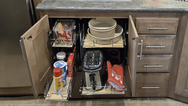 Sliding racks installed inside of an RV camper kitchen