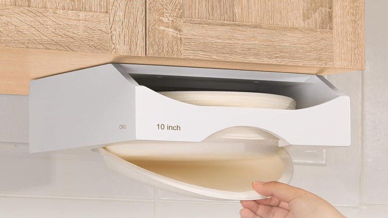 A paper plate dispenser installed beneath a cabinet