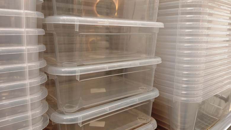 Stacks of clear plastic bins at a supermarket