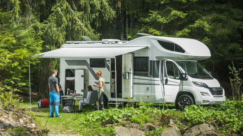 People outside of an RV