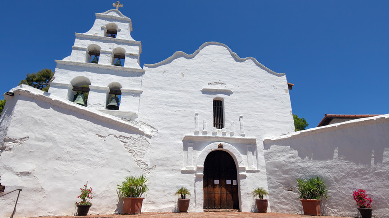 The facade of the Mission San Diego de Alcala on a sunny day
