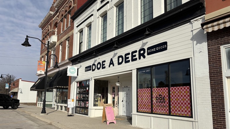 Doe a Deer flagship storefront surrounded by other historic bulidings