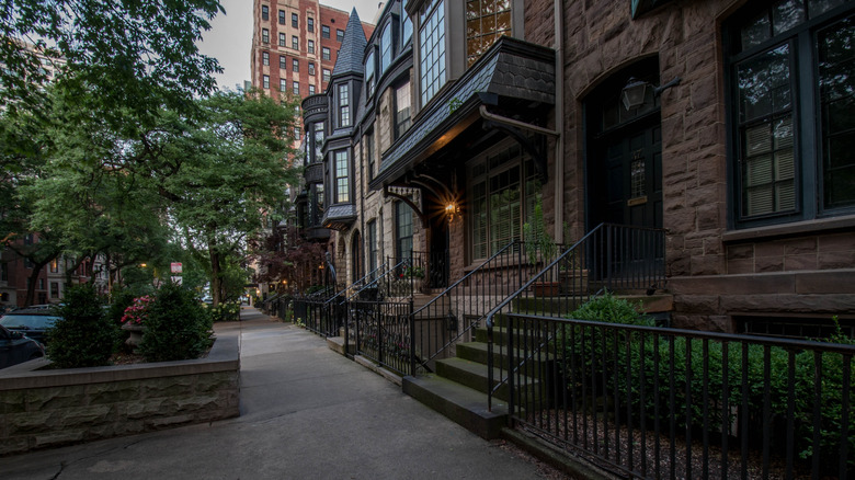 Row of historic homes on a tree-lined street in the wealthy Gold Coast neighborhood of Chicago