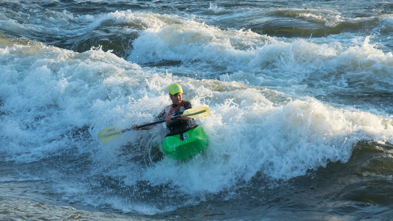A kayaker on Brennan's Wave in the Clark Fork River