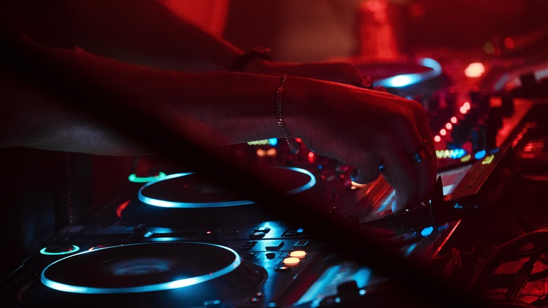 A DJ set lit up during a rave