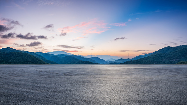 Road, mountains, clouds, and sky landscape