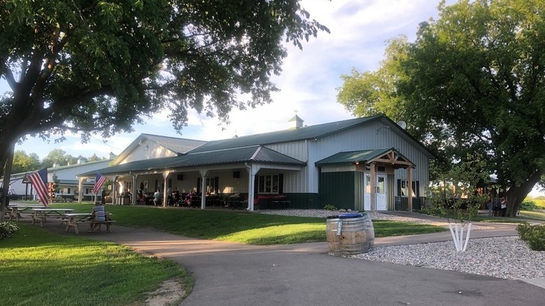 A winery's tasting room surrounded by trees and American flags.