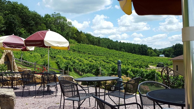 Tables and chairs overlooking vineyards at Wollersheim Winery
