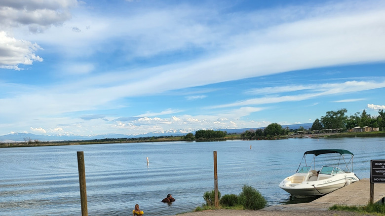 People and a boat in the water at Sweitzer Lake State Park in Delta, Colorado