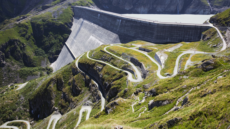 A winding path leads to the crest of the Grande Dixence dam.