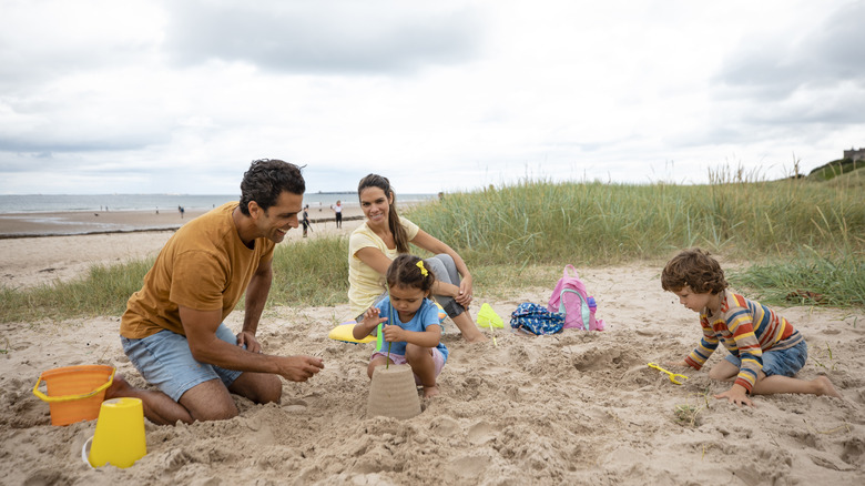 Family playing in the sand