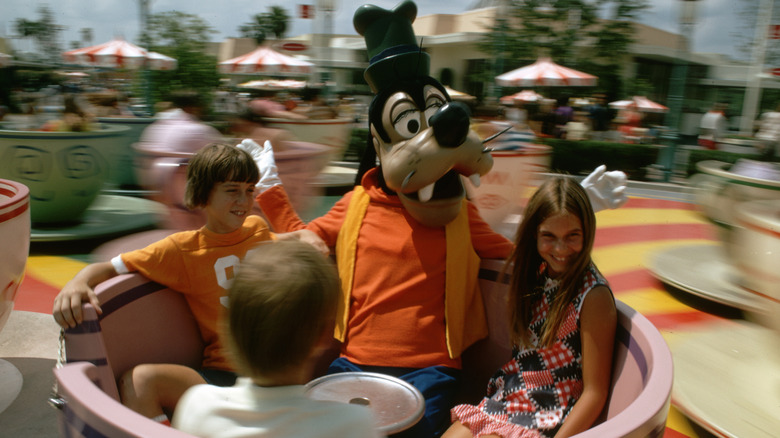 Guests and Goofy ride the Mad Hatter's Tea Party Ride in Disney's Magic Kingdom Park in 1972