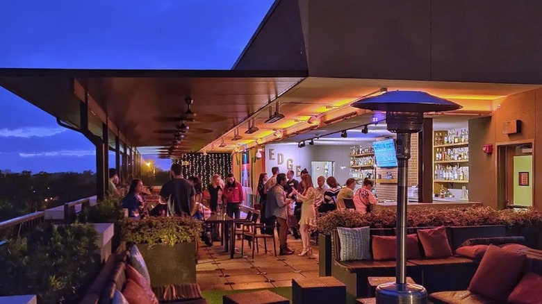 People clustered around Edge rooftop bar in Tampa at night