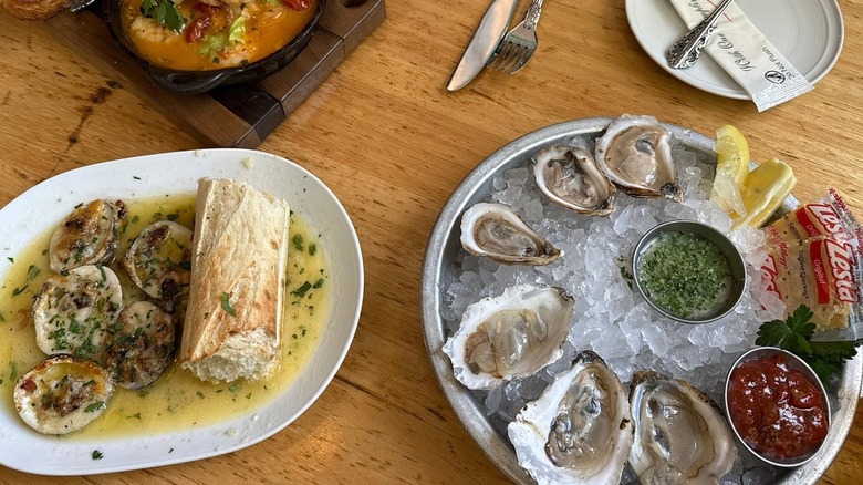 Baked oysters with baguette, raw oysters on the half-shell, and a seafood stew at The Pearl on Water Street in Tampa's Channel District