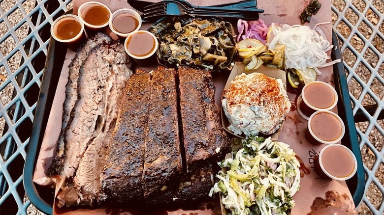 A tray loaded with meat and sides from Lewis Barbecue