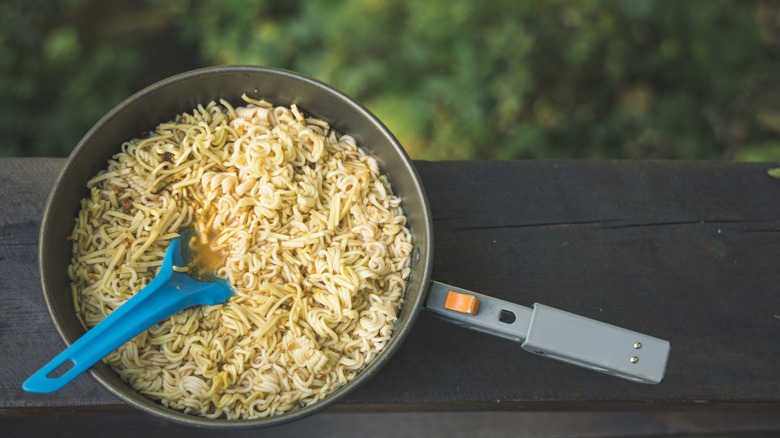 A bowl full of rame noodles against the outdoors