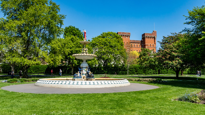 Decorated fountain and heritage red brick building in Vivary Park