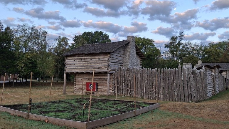 Historic Mansker's Station in Goodlettsville, Tennessee, against a cloudy soft blue sky.