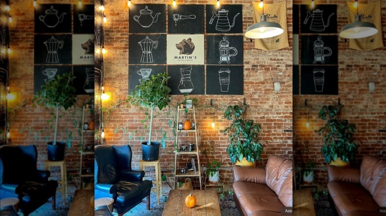 Interior of Martin's Coffee & Bakery with seating, plants, and wall decor