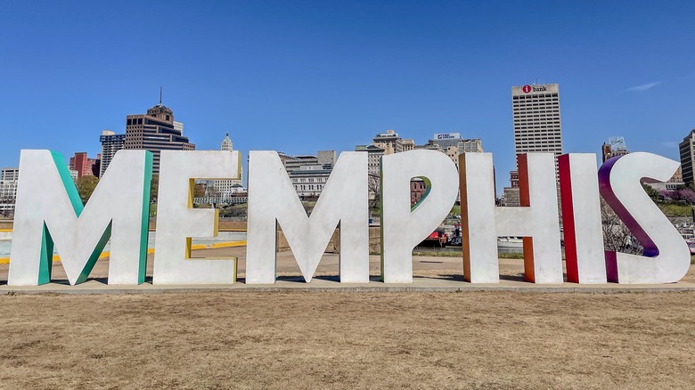 metal letters spelling 'Memphis' with downtown as backdrop