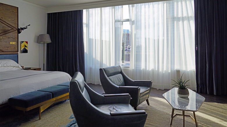 A room with floor to ceiling windows in Thompson Nashville Hotel