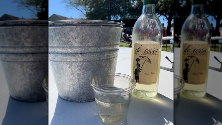 Somerville white wine bottle next to wine cooler
