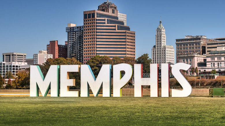 Memphis sign on grass in front of buildings