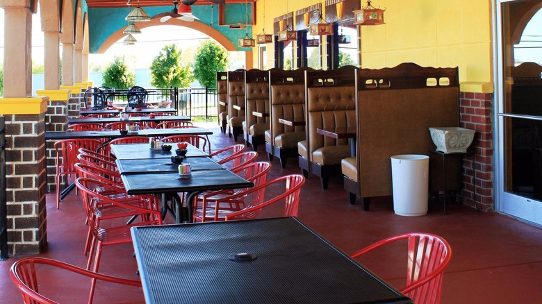 Outdoor seating area at Margarita House, with tables, chairs, and booth seating