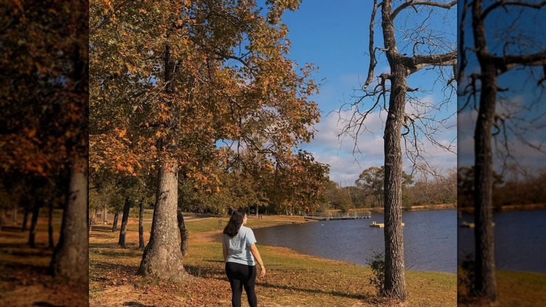 A woman walking along Sullivan Lake in Fort Boggy State Park