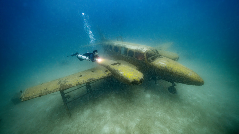 Scuba diver exploring a sunken plane