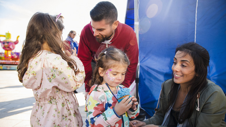 Family at a festival and face painting