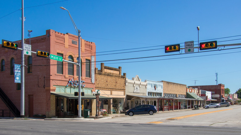 Main Street with buildings and traffic lights in downtown Smithville, Texas