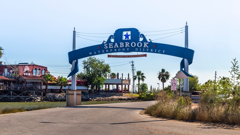 A blue sign above the street, reading Seabrook Waterfront District