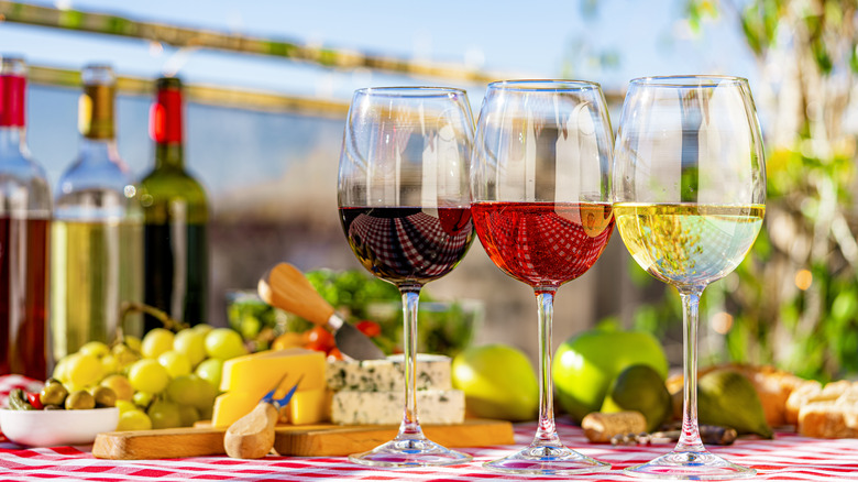 Wine, cheese, and fruit pairing on a outdoors restaurant table.