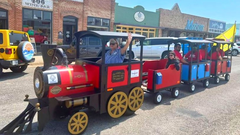 People riding the train at the Rockport Cultural Arts District