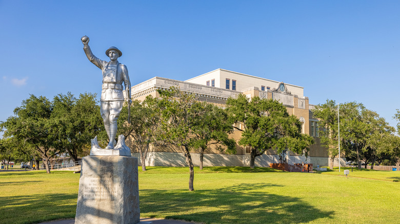 A World War I monument featuring a soldier with one arm upraised, in San Patricio County