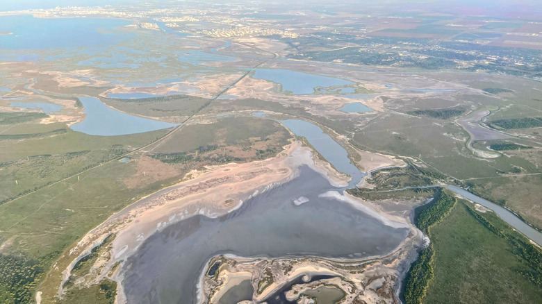 An aerial view of the lagoon around Sinton, Texas, with greenery and blue waterways