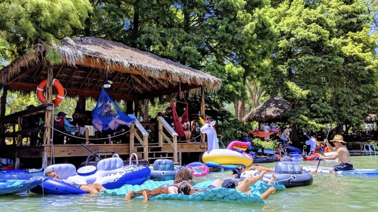 Guests lounge in a cabana and soak up the sun at Son's Island, Texas