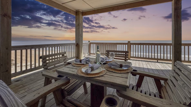 Table set on porch at sunset