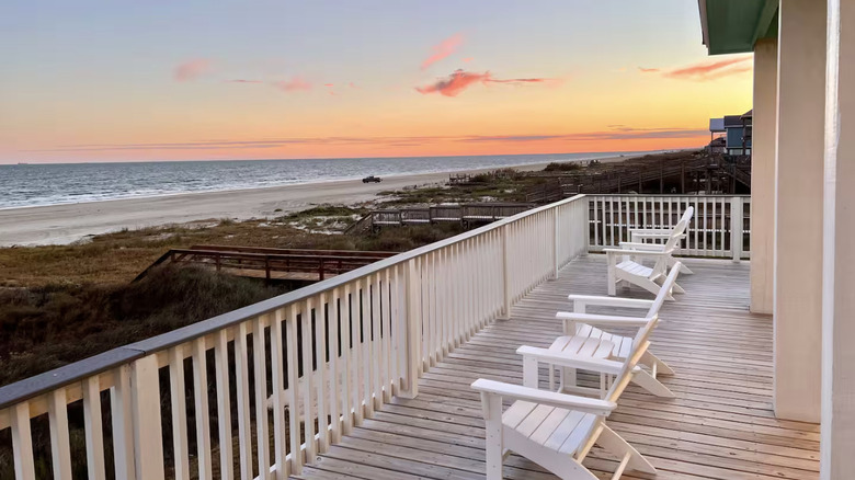 Patio with white chairs at sunset