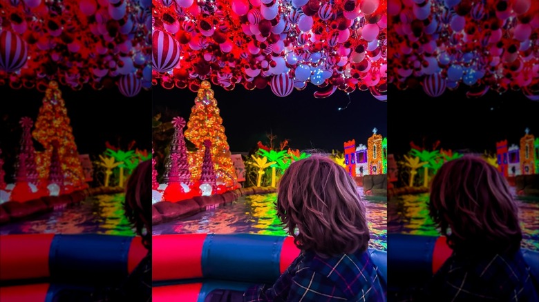 A woman floating down a festive lazy river at Club Westside in Texas